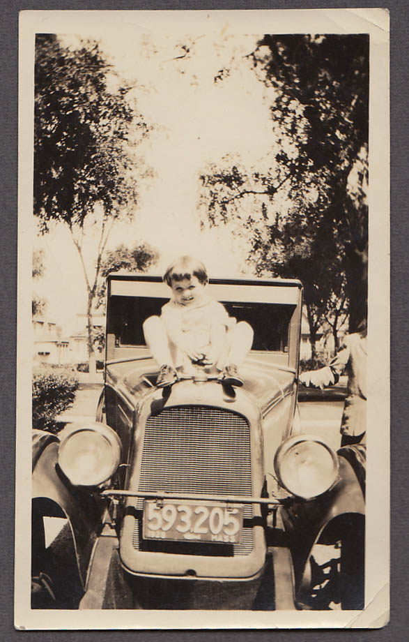 Image for Boy on hood holding MotoMeter Masschusetts license plate 593205 1928 photo